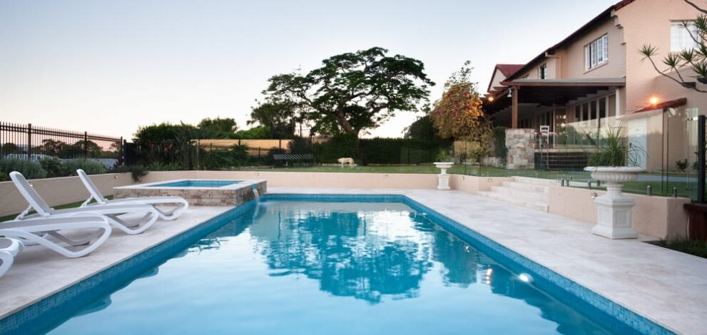 A beautiful inground empty pool in a backyard. Find out how long you can leave your pool empty.