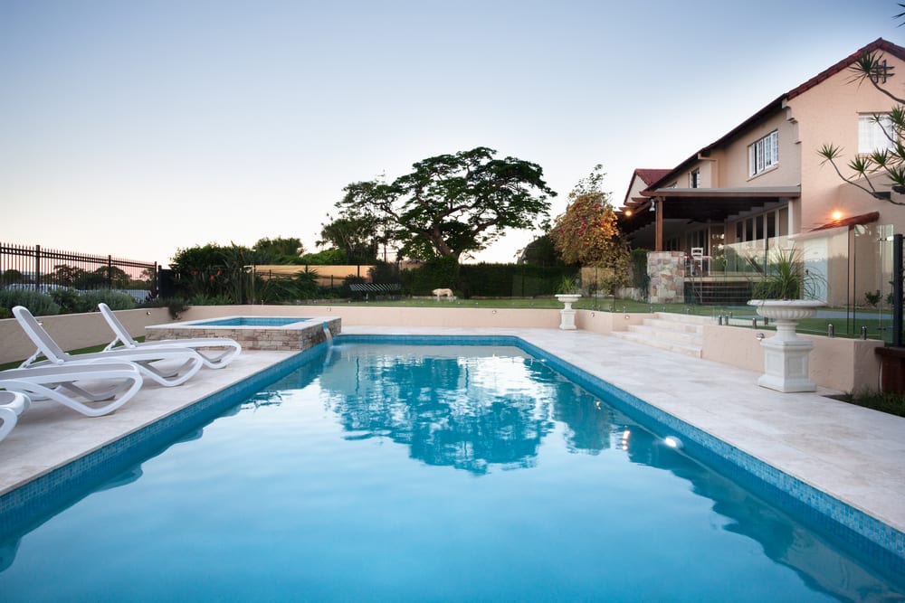 A beautiful inground empty pool in a backyard. Find out how long you can leave your pool empty.