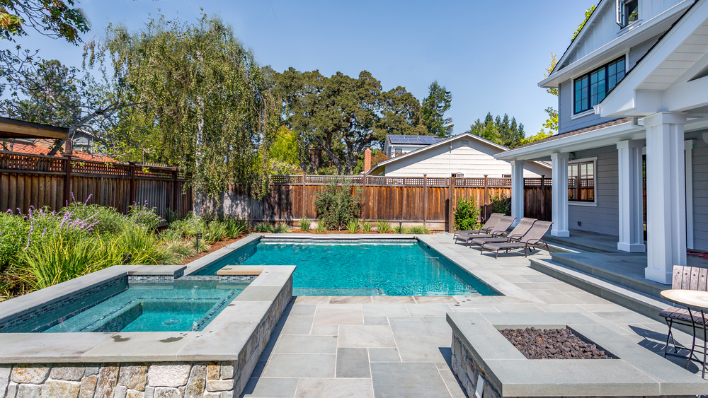 A beautiful backyard pool surrounded by tall fences and shrubbery. Are you looking for ways to build up your backyard privacy from peering eyes? Here are some ideas to get you started!
